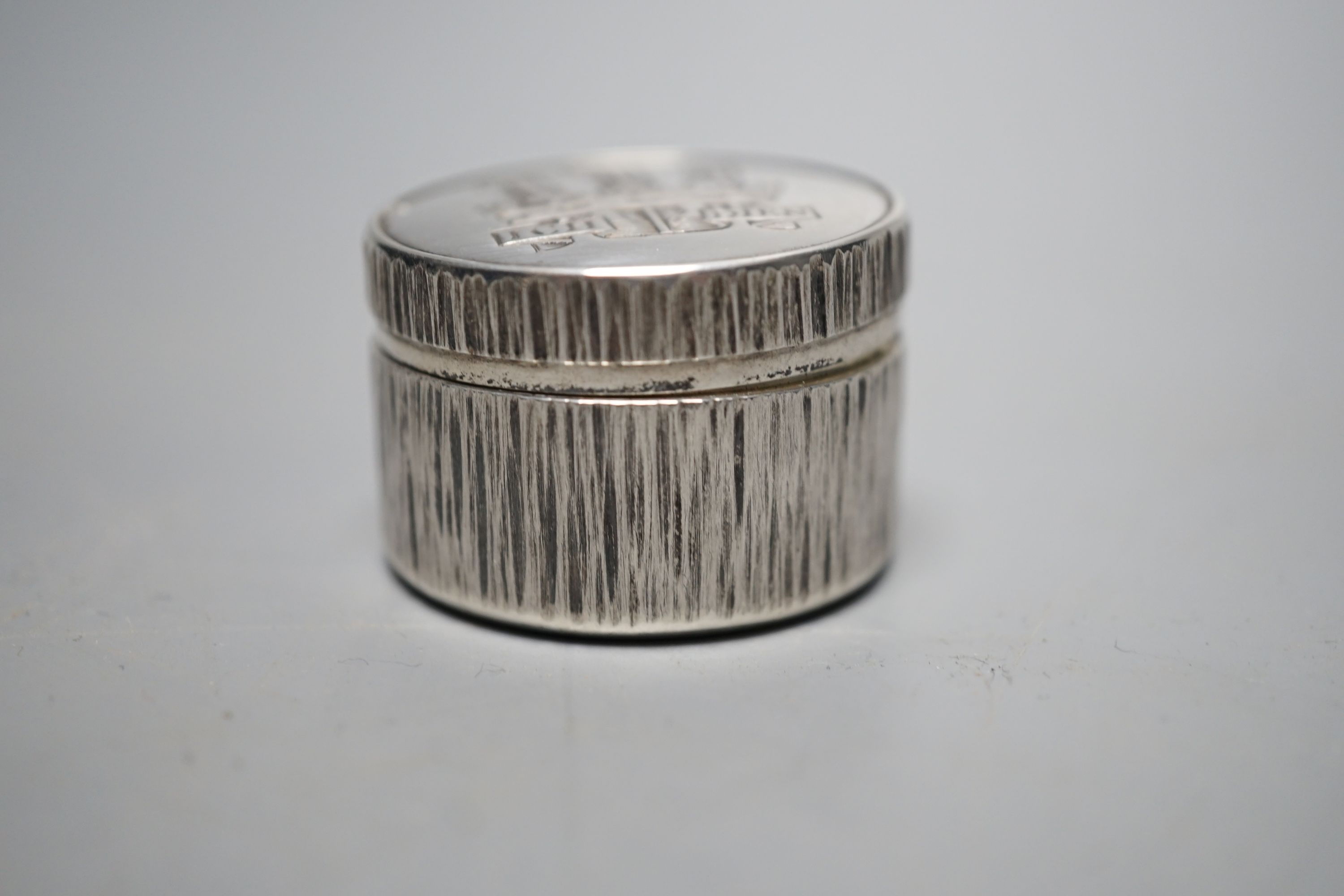 Adrian Gerald Benney- A modern textured silver pill box, engraved with the Prince of Wales feathers, London, 1997